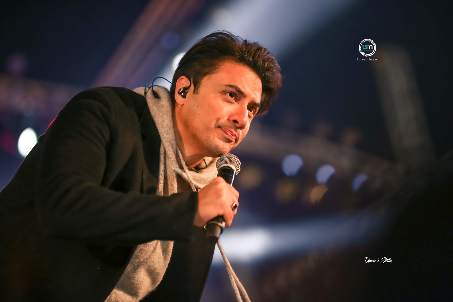 Vocalist performing live on stage with microphone