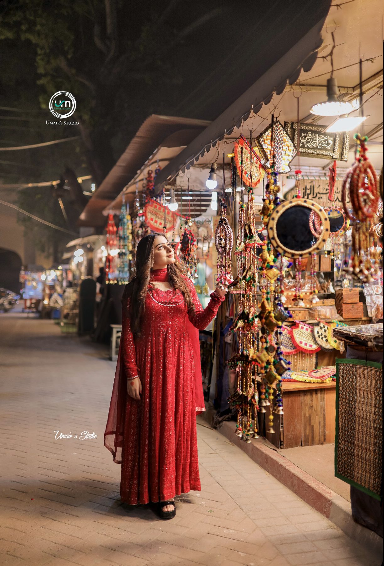 Woman in red shalwar kameez at a colourful Lahore bazaar
