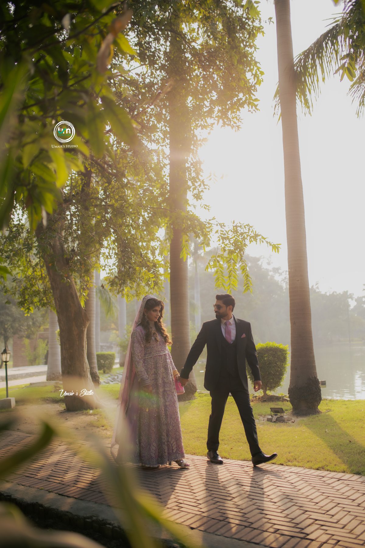 Couple walking through golden morning light at a Lahore garden shoot