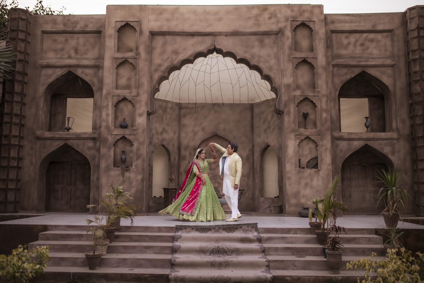 Couple at a historic Mughal facade during a pre-wedding shoot